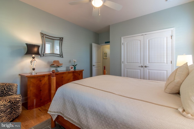 bedroom with hardwood / wood-style flooring, a closet, and ceiling fan