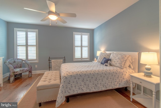 bedroom featuring multiple windows, light wood-type flooring, and ceiling fan