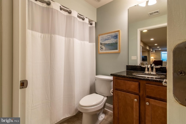 bathroom featuring tile patterned flooring, vanity, and toilet