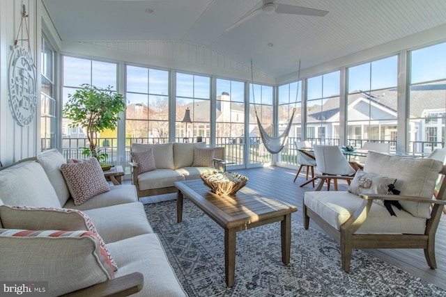 sunroom featuring plenty of natural light, ceiling fan, and lofted ceiling