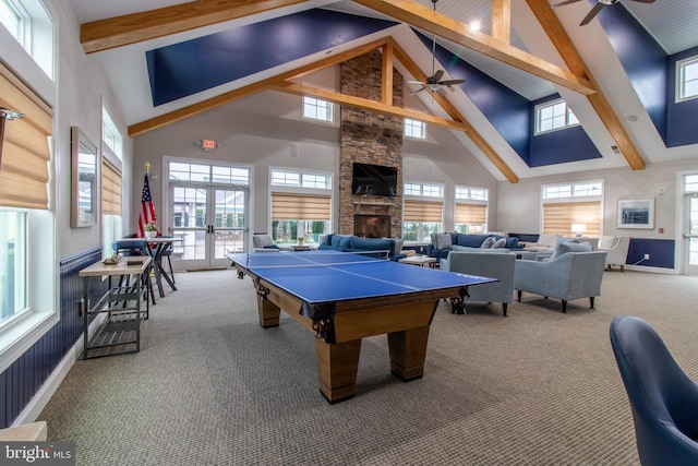 recreation room with carpet flooring, ceiling fan, and high vaulted ceiling