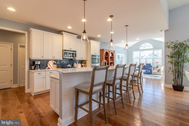 kitchen featuring white cabinetry, an island with sink, and stainless steel appliances