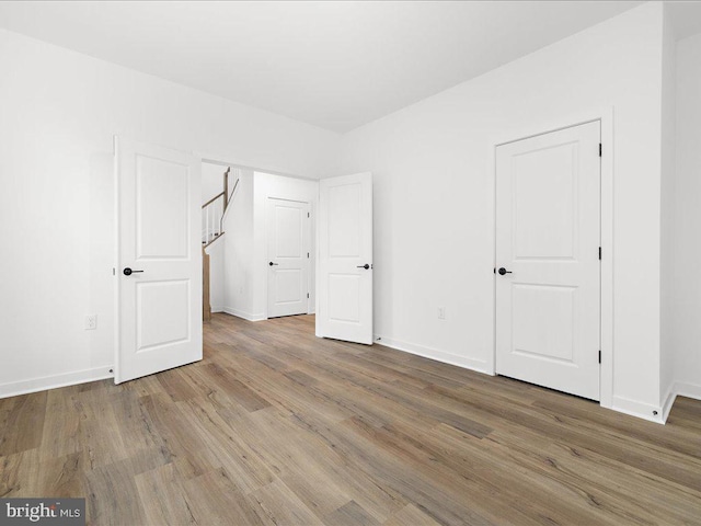 unfurnished bedroom with wood-type flooring