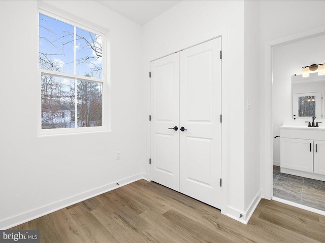 unfurnished bedroom featuring a closet and light hardwood / wood-style flooring