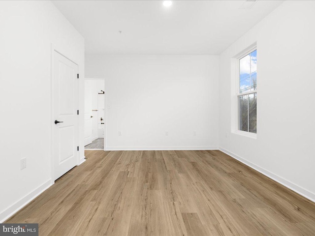 empty room with light hardwood / wood-style flooring