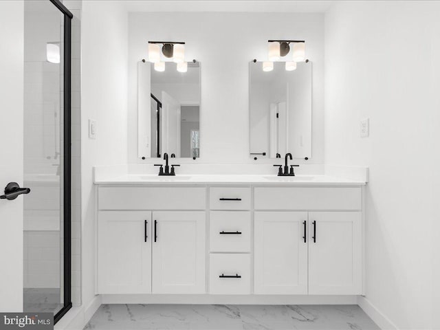 bathroom with vanity and a shower with door