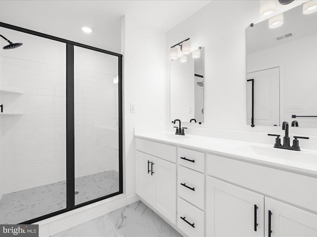 bathroom featuring vanity and a shower with shower door