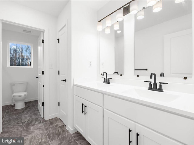 bathroom featuring vanity and toilet