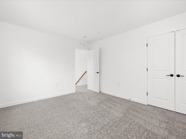 unfurnished room with light carpet