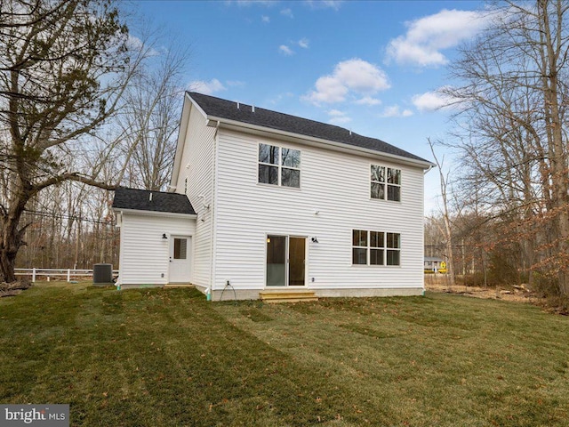 back of property with a lawn and central AC unit