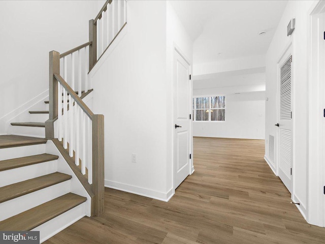 staircase featuring hardwood / wood-style flooring