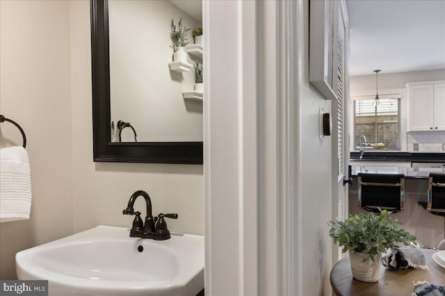 bathroom featuring sink and tasteful backsplash