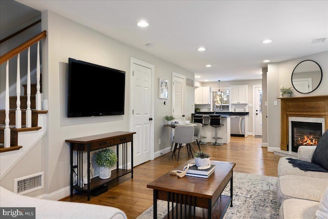 living room featuring a fireplace and light hardwood / wood-style floors