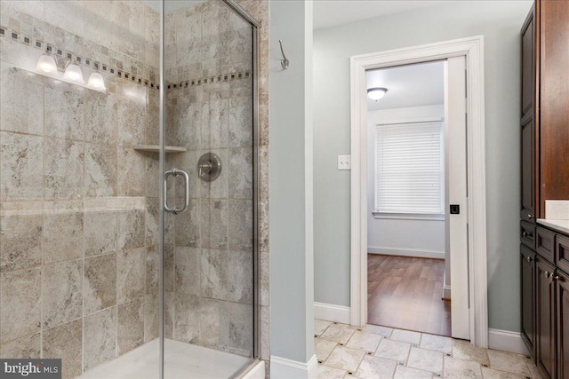 bathroom featuring vanity and an enclosed shower