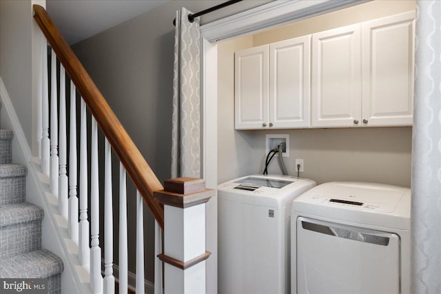 washroom with cabinets and independent washer and dryer