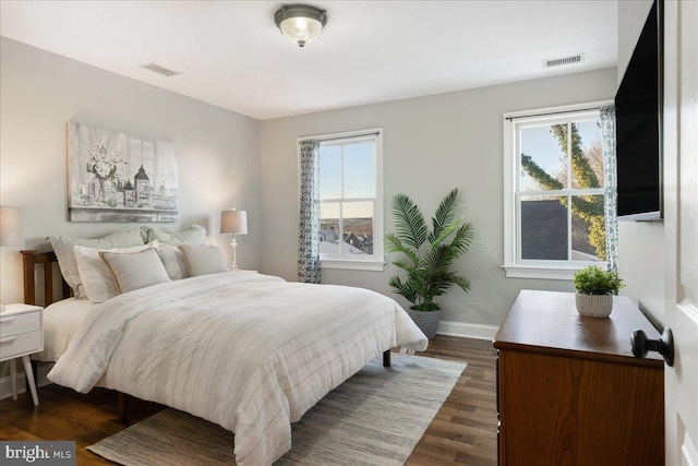 bedroom with dark hardwood / wood-style flooring