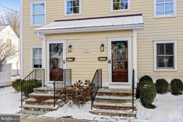 view of snow covered property entrance