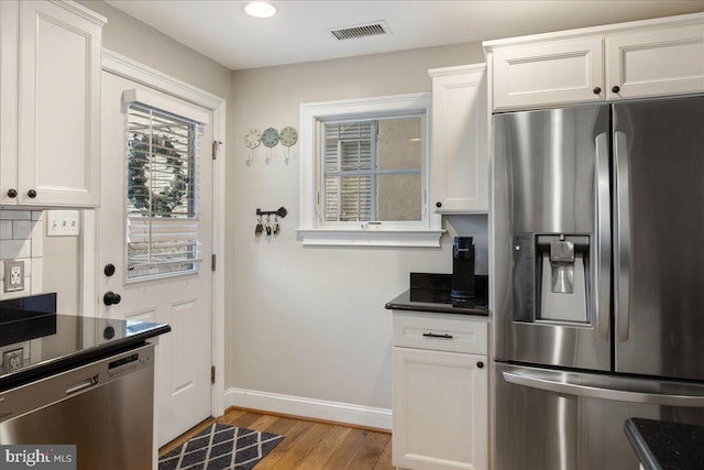 kitchen featuring light hardwood / wood-style flooring, white cabinets, and stainless steel appliances