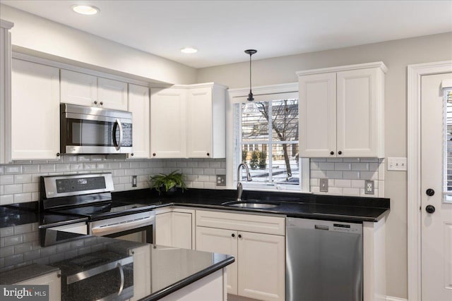 kitchen featuring stainless steel appliances, white cabinetry, and sink