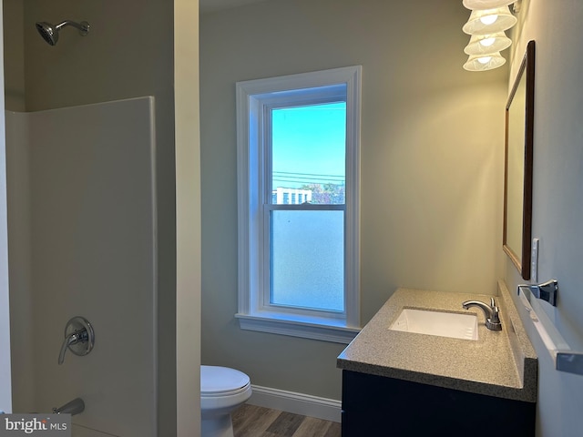 full bathroom with vanity, toilet, wood-type flooring, and a wealth of natural light