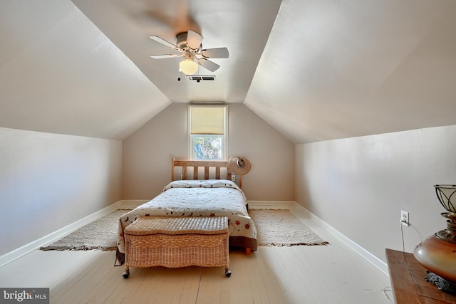 bedroom featuring ceiling fan, light hardwood / wood-style floors, and vaulted ceiling