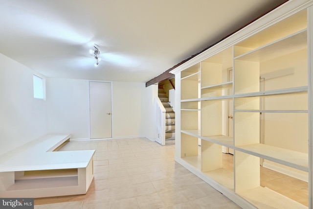 basement featuring light tile patterned floors