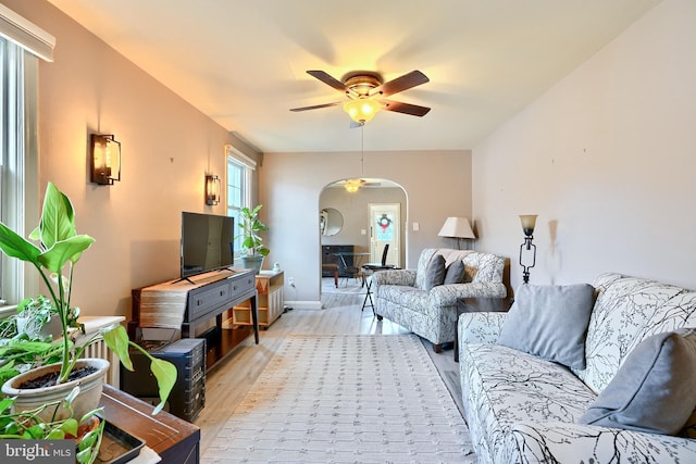 living room featuring light hardwood / wood-style flooring and ceiling fan