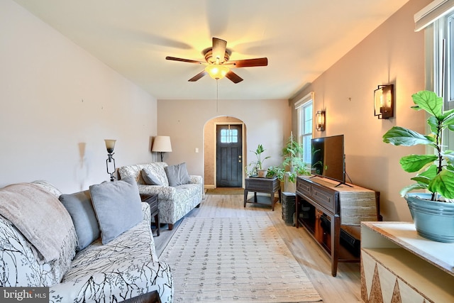 living room featuring ceiling fan and light hardwood / wood-style flooring