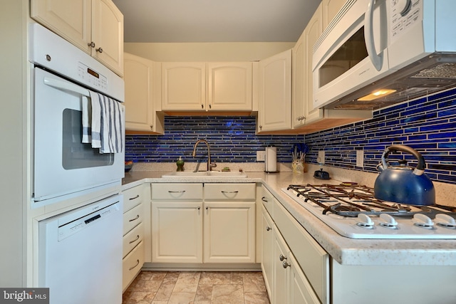 kitchen with white cabinets, white appliances, tasteful backsplash, and sink