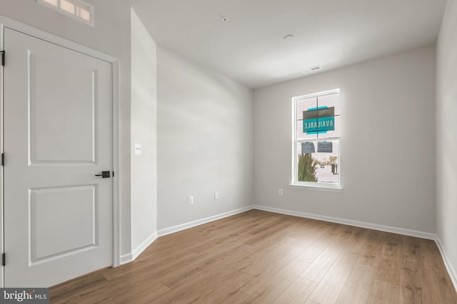 unfurnished room with light hardwood / wood-style floors