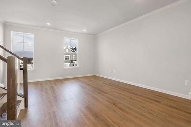 empty room with wood-type flooring and ornamental molding