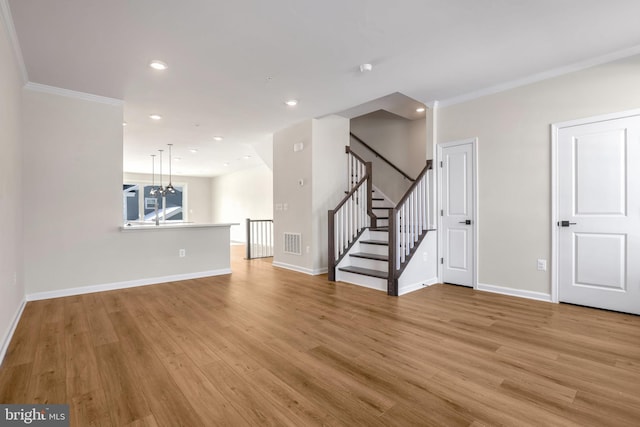 unfurnished living room with light hardwood / wood-style flooring and ornamental molding