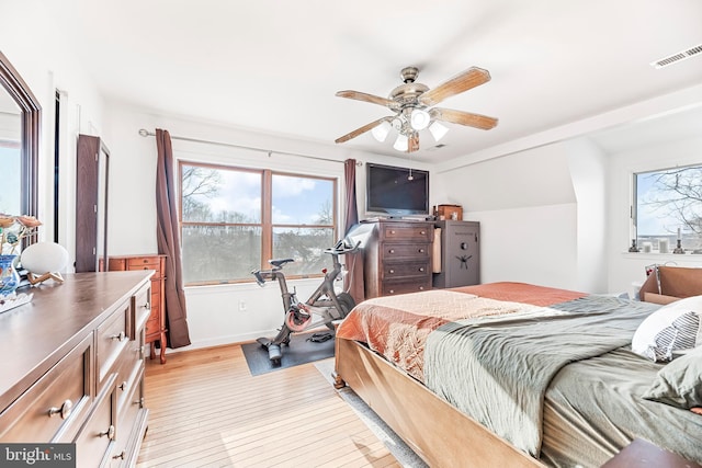 bedroom with ceiling fan and light hardwood / wood-style flooring