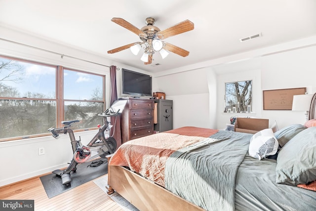 bedroom with ceiling fan and light hardwood / wood-style floors