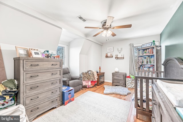 bedroom with ceiling fan and light hardwood / wood-style flooring