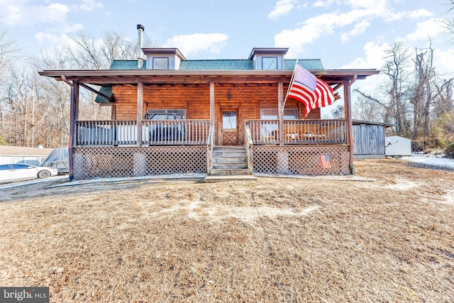 back of property featuring a yard and a porch