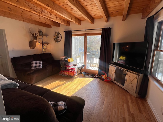 living room featuring beam ceiling, light wood-type flooring, and wood ceiling