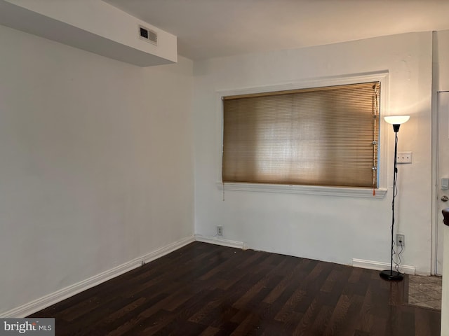 unfurnished room featuring dark wood-type flooring