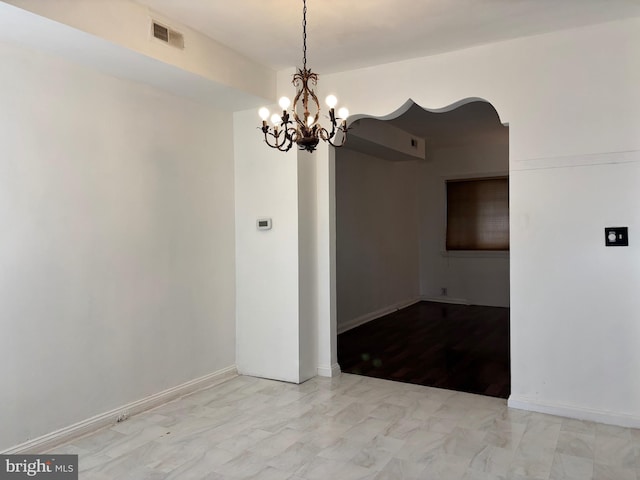 empty room featuring a chandelier