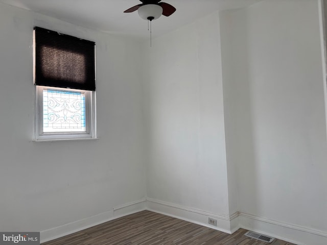 unfurnished room featuring ceiling fan and dark wood-type flooring