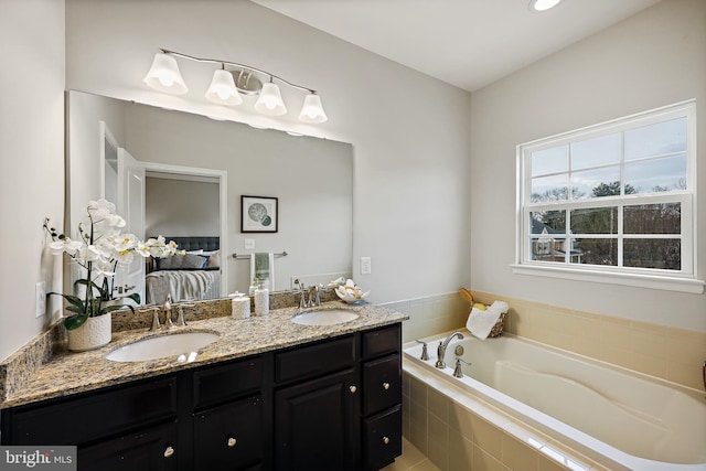 bathroom with vanity and a relaxing tiled tub