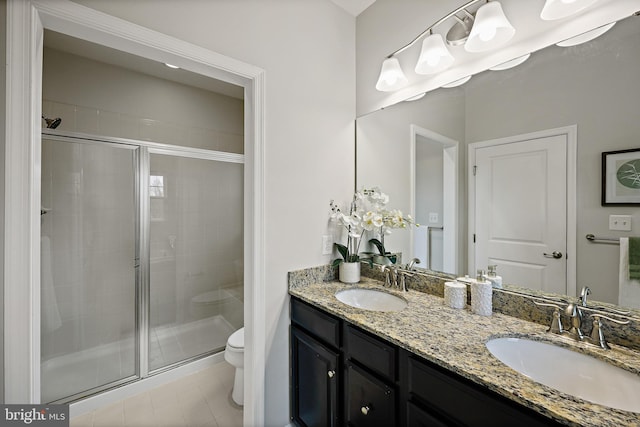 bathroom featuring tile patterned floors, toilet, an enclosed shower, and vanity