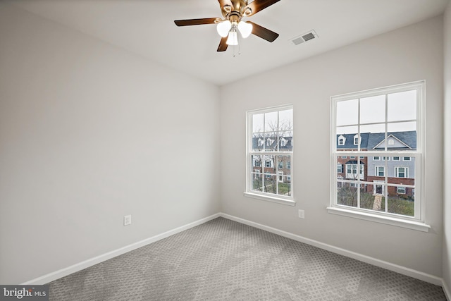 carpeted spare room with ceiling fan