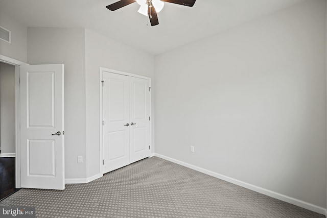 unfurnished bedroom with ceiling fan, a closet, and light colored carpet