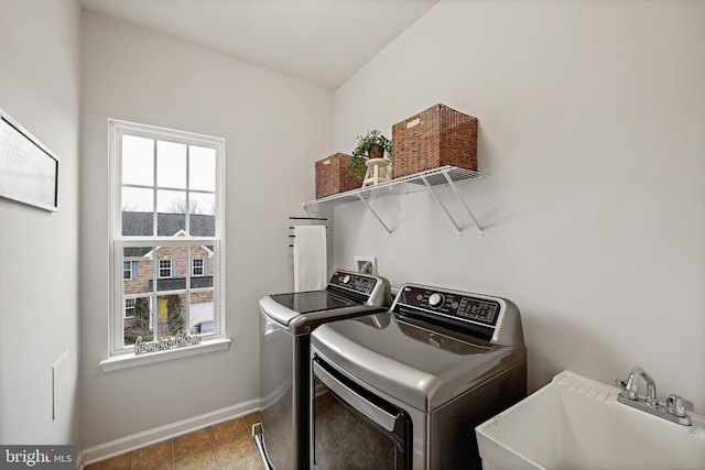 washroom with washing machine and dryer and sink