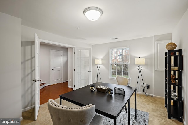 home office featuring french doors and carpet