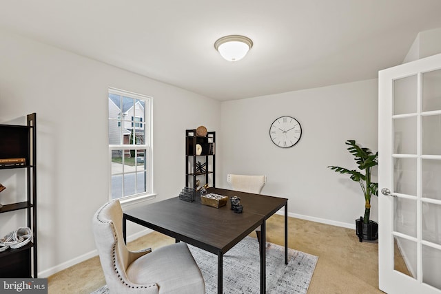 office space featuring light carpet and french doors