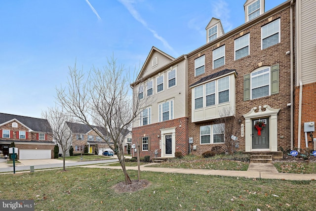 multi unit property featuring a garage and a front yard