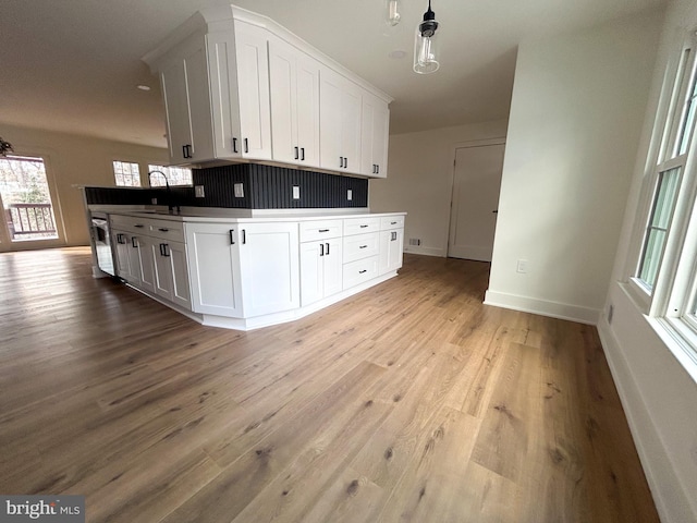 kitchen featuring white cabinetry, sink, and light hardwood / wood-style floors