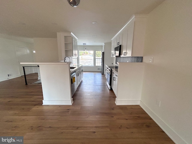 kitchen with hanging light fixtures, white cabinetry, a kitchen island with sink, and appliances with stainless steel finishes